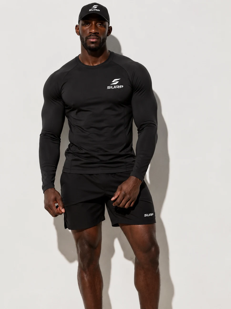 Male SURP athlete wearing a black long sleeve, shorts and cap